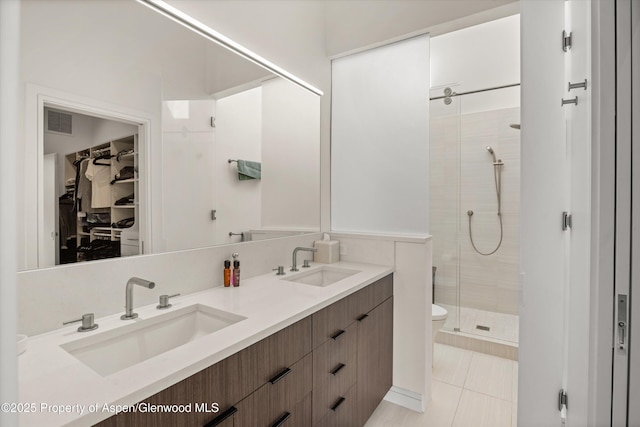 155 Lone Pine Rd Unit 2, Aspen, CO 81611 - bathroom featuring a shower stall, double vanity, tile patterned flooring, and a walk in closet