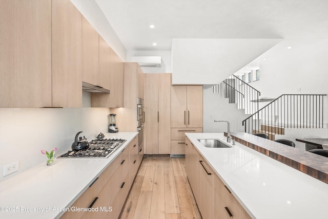 155 Lone Pine Rd Unit 2, Aspen, CO 81611 - kitchen with light brown cabinetry, appliances with stainless steel finishes, modern cabinets, and recessed lighting