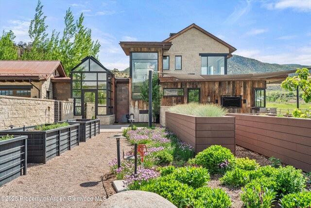 295 Aspen Valley Ranch Rd, Woody Creek, CO 81656 - back of house featuring a vegetable garden