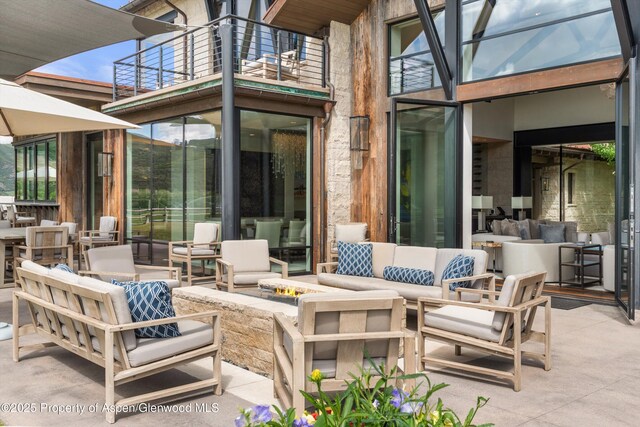 295 Aspen Valley Ranch Rd, Woody Creek, CO 81656 - view of patio / terrace featuring a balcony and an outdoor living space with a fire pit