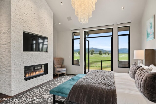 295 Aspen Valley Ranch Rd, Woody Creek, CO 81656 - bedroom with access to outside, a chandelier, a fireplace, and high vaulted ceiling