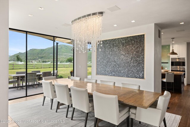 295 Aspen Valley Ranch Rd, Woody Creek, CO 81656 - dining space with a mountain view, wood finished floors, floor to ceiling windows, a chandelier, and recessed lighting