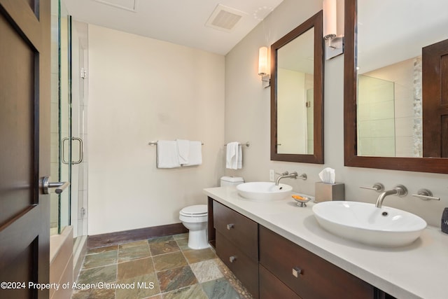 bathroom with vanity, toilet, and walk in shower