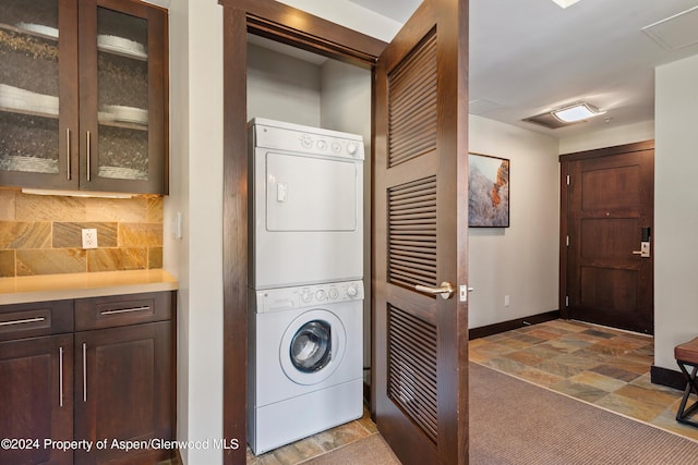 washroom with stacked washer and clothes dryer