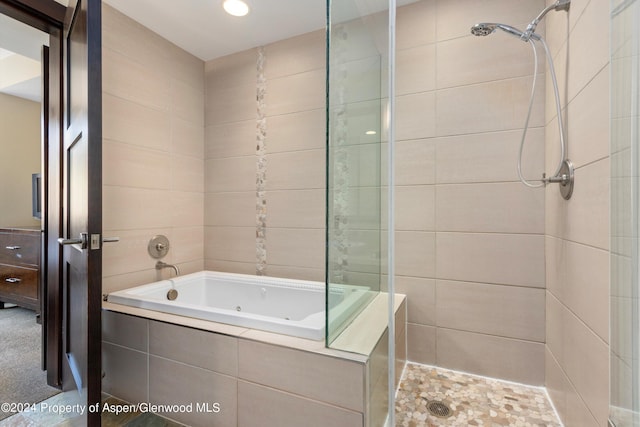 bathroom featuring shower with separate bathtub