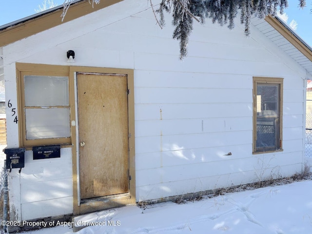 view of snow covered property entrance