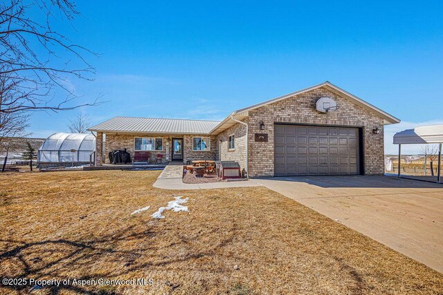 37 Pronghorn Rd, Craig, CO 81625 - single story home featuring concrete driveway, an attached garage, an exterior structure, a front yard, and brick siding