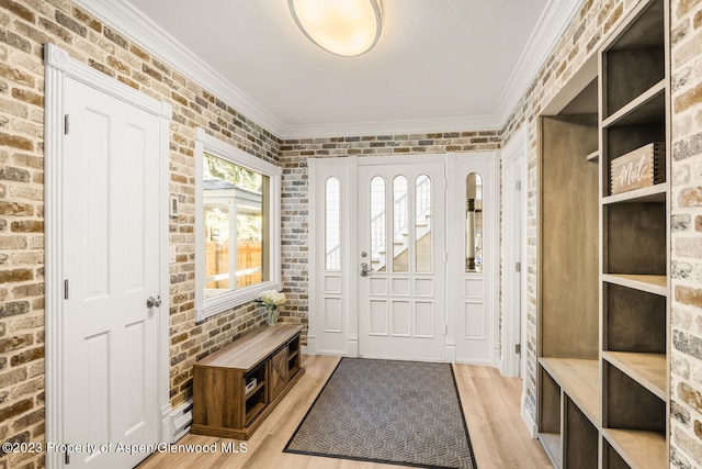 1195 E Cooper Ave Unit A, Aspen, CO 81611 - mudroom featuring ornamental molding, light wood-style flooring, and brick wall