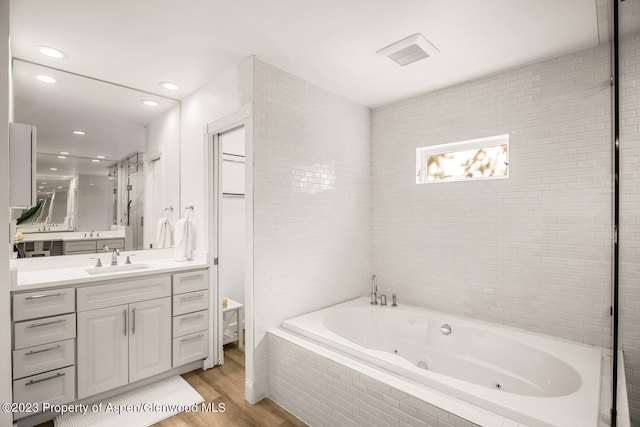 1195 E Cooper Ave Unit A, Aspen, CO 81611 - bathroom featuring a jetted tub, wood finished floors, vanity, and recessed lighting