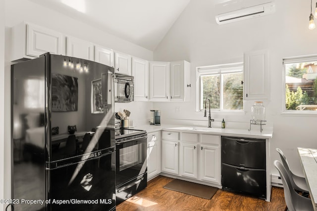 1195 E Cooper Ave Unit A, Aspen, CO 81611 - kitchen featuring black appliances, an AC wall unit, light countertops, white cabinets, and high vaulted ceiling