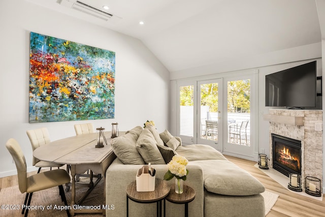 1195 E Cooper Ave Unit A, Aspen, CO 81611 - living area featuring lofted ceiling, wood finished floors, a stone fireplace, and recessed lighting
