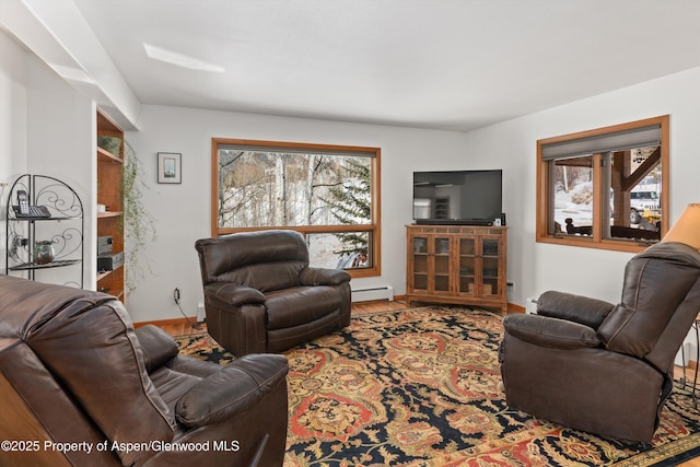 living room with a baseboard heating unit and baseboards