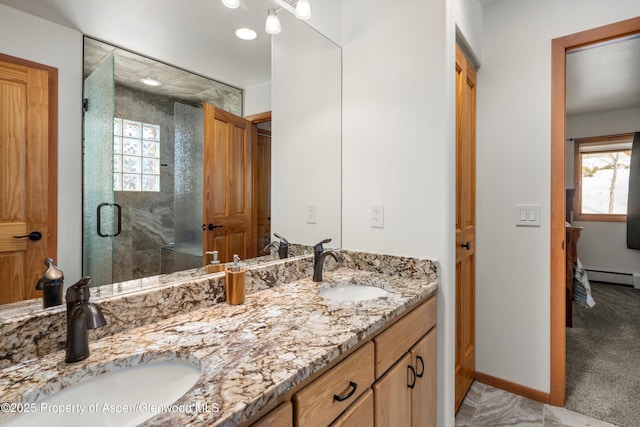 bathroom featuring a healthy amount of sunlight, a shower stall, and a sink