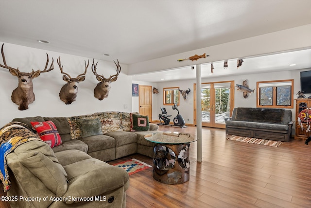 living room with french doors, wood finished floors, and recessed lighting