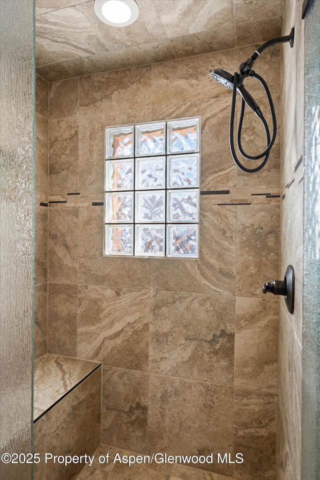 bathroom with tiled shower