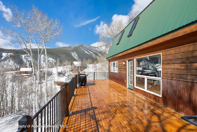 snow covered deck featuring a mountain view