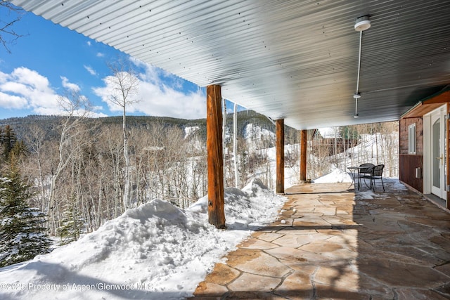 snow covered patio featuring outdoor dining area