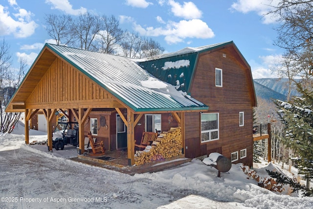 exterior space with metal roof and a gambrel roof