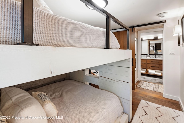800 S Mill St Unit 105, Aspen, CO 81611 - bedroom featuring wood finished floors and ensuite bathroom