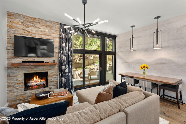 800 S Mill St Unit 105, Aspen, CO 81611 - living area featuring a chandelier, a fireplace, and wood finished floors