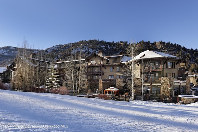 snow covered house with a mountain view