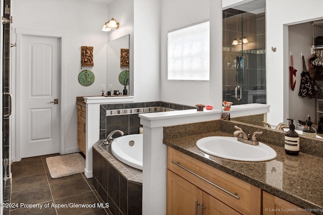 bathroom featuring tile patterned floors, vanity, and shower with separate bathtub