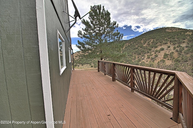 wooden deck featuring a mountain view