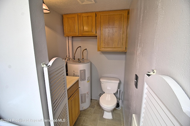 bathroom with a textured ceiling, toilet, and water heater