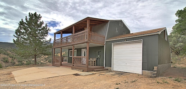 view of front of house featuring a garage and a deck