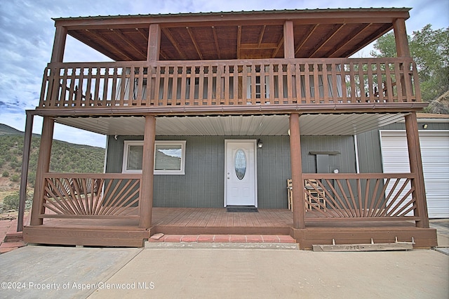 view of exterior entry featuring a deck