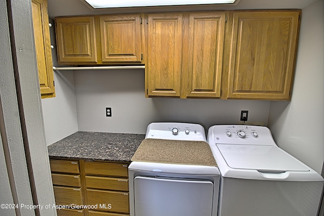 washroom featuring washer and dryer and cabinets