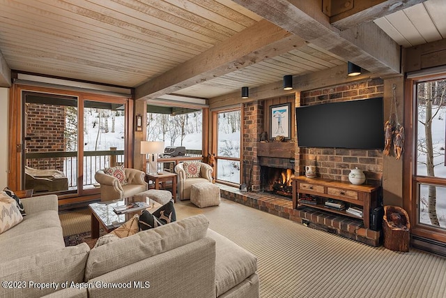 living room with carpet floors, a fireplace, and beamed ceiling