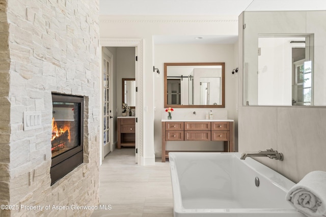 2959 County Road 103, Carbondale, CO 81623 - bathroom featuring a fireplace, a freestanding bath, and vanity
