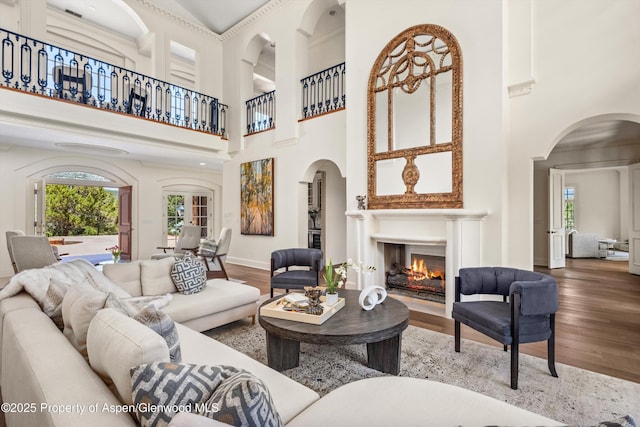 2959 County Road 103, Carbondale, CO 81623 - living area with healthy amount of natural light, wood finished floors, a towering ceiling, and a warm lit fireplace