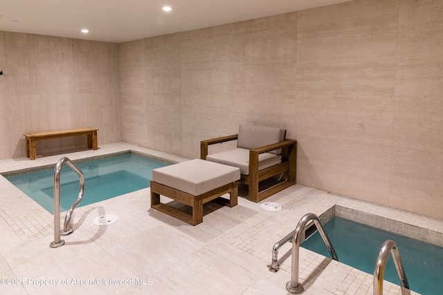 view of pool featuring an indoor hot tub and a swimming pool