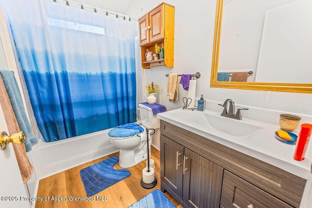 full bath featuring shower / bath combination with curtain, toilet, vanity, and wood finished floors