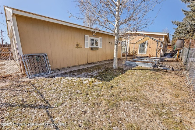 back of house featuring fence