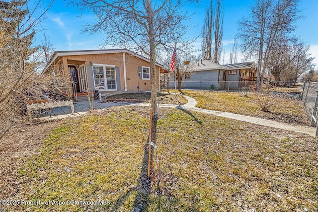 exterior space featuring a front yard and fence