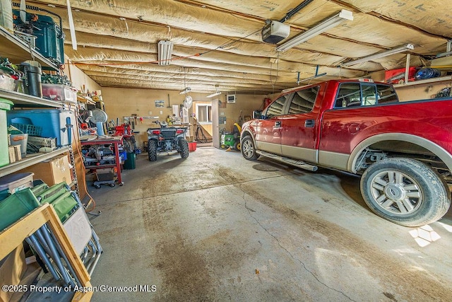 garage featuring a workshop area and a garage door opener