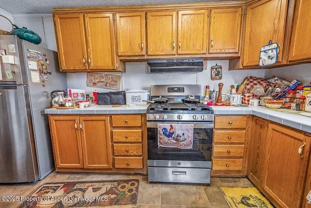 kitchen with extractor fan, brown cabinets, and appliances with stainless steel finishes