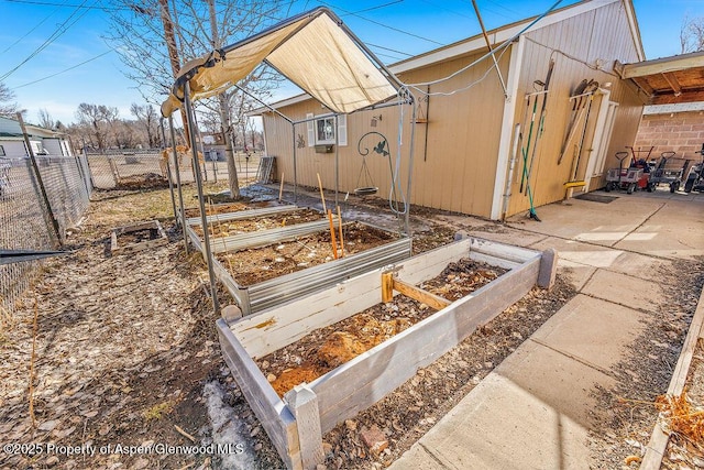 view of yard featuring a patio area, a vegetable garden, and fence