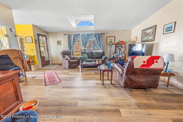 living area with wood finished floors and a textured ceiling