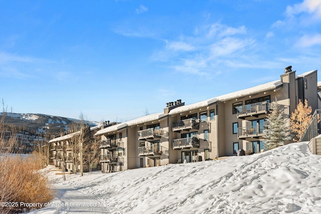 snow covered property with a mountain view