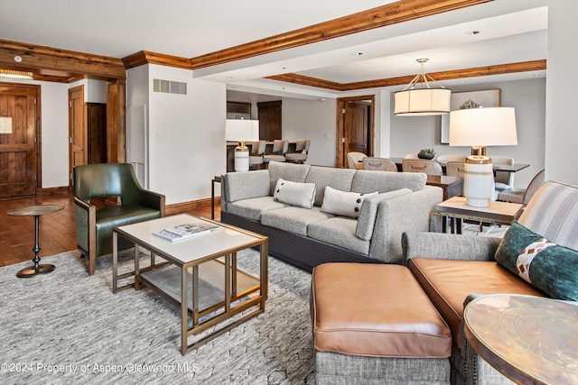 living room featuring hardwood / wood-style flooring and crown molding