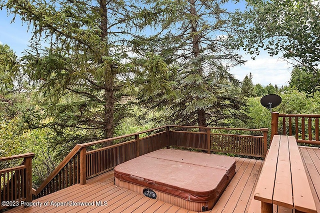 wooden terrace with a covered hot tub