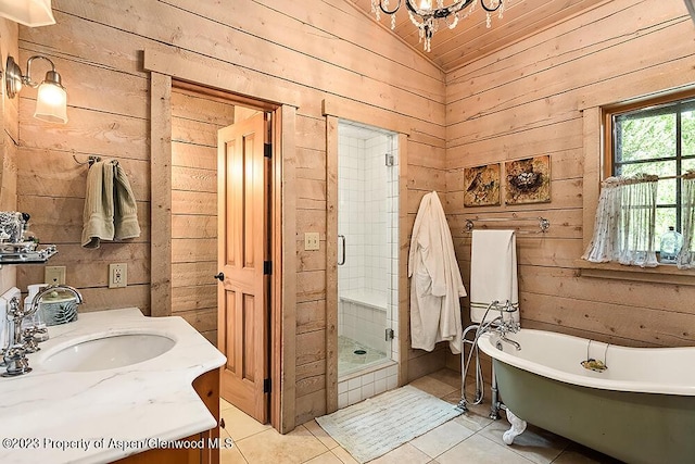 bathroom featuring tile patterned flooring, vanity, lofted ceiling, and wooden walls