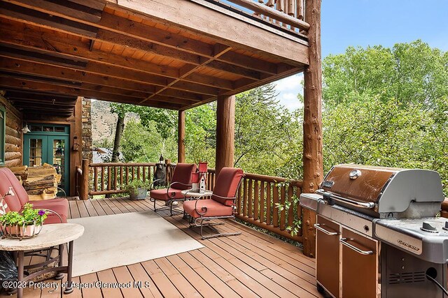 wooden terrace featuring grilling area