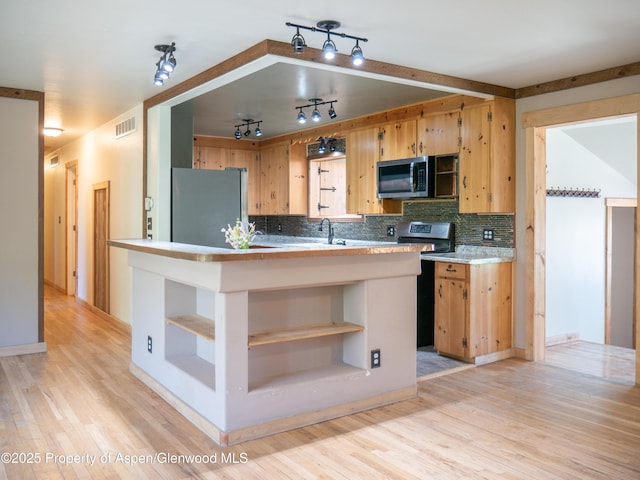 783 Orchard Rd, Montrose, CO 81401 - kitchen with appliances with stainless steel finishes, open shelves, track lighting, light countertops, and light wood-type flooring