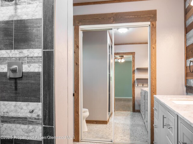 783 Orchard Rd, Montrose, CO 81401 - bathroom with vanity, toilet, a ceiling fan, a shower, and tile patterned flooring