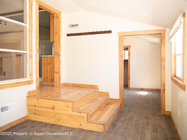 783 Orchard Rd, Montrose, CO 81401 - hall featuring vaulted ceiling, baseboards, wood finished floors, and stairs
